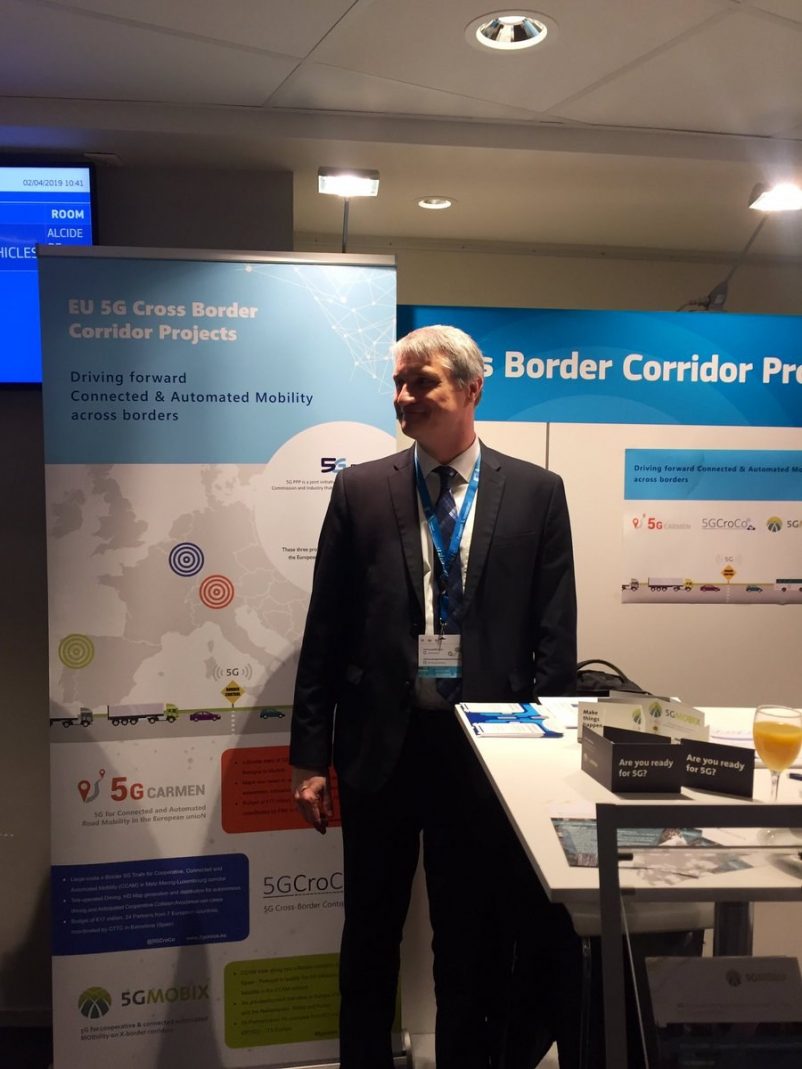Francois Fischer, 5G-MOBIX project coordinator in from of the 5G-MOBIX stand